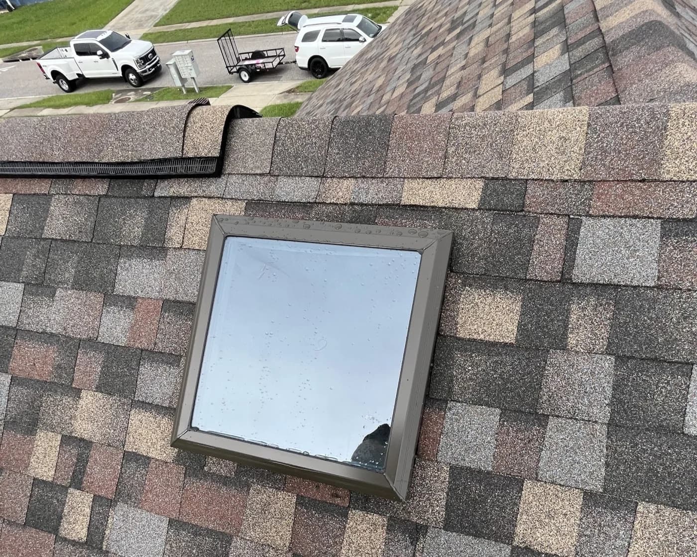 Hail-damaged skylight and surrounding roof section on a Florida home