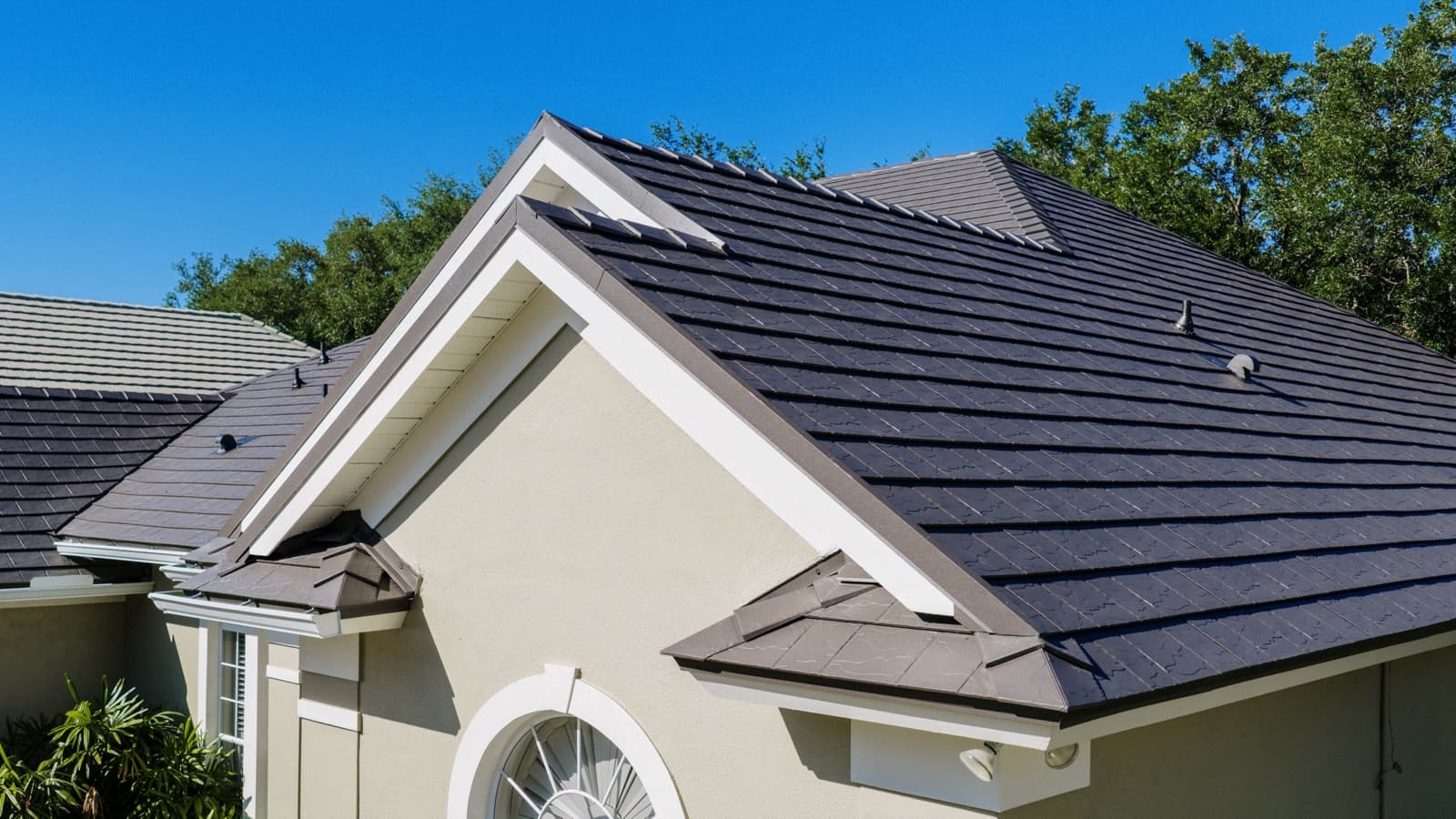 Standing-seam metal roof on a Tampa Bay home under a clear sky