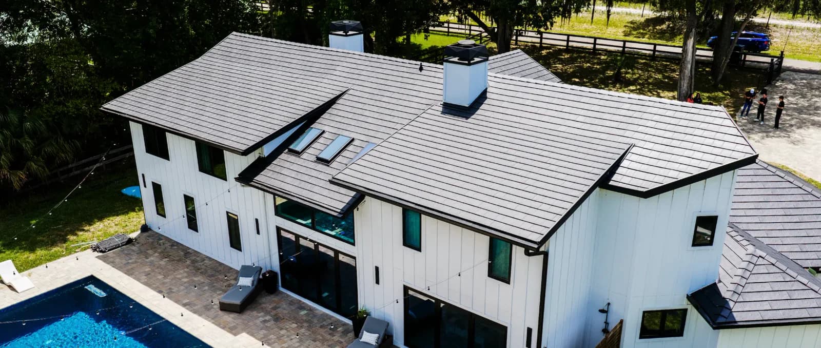 Aerial view of a Metlok pressed-steel roof installed on a modern Florida home with a pool