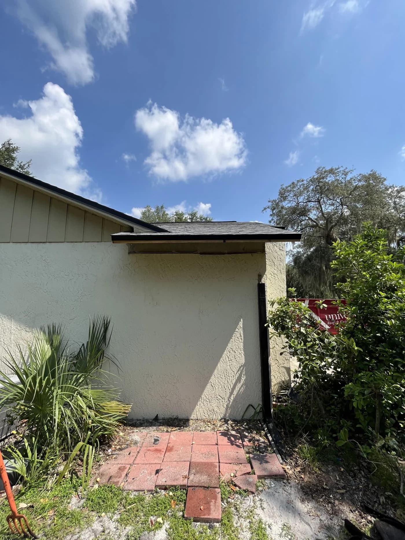 Tampa Bay neighborhood roof after a storm, with debris scattered across the property