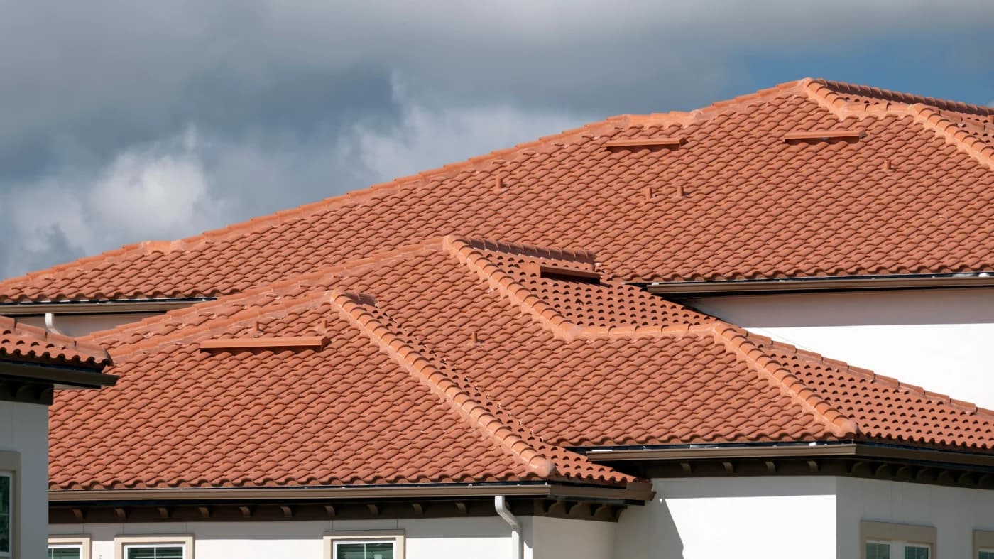 Terracotta barrel tile roof against a dramatic Florida storm sky