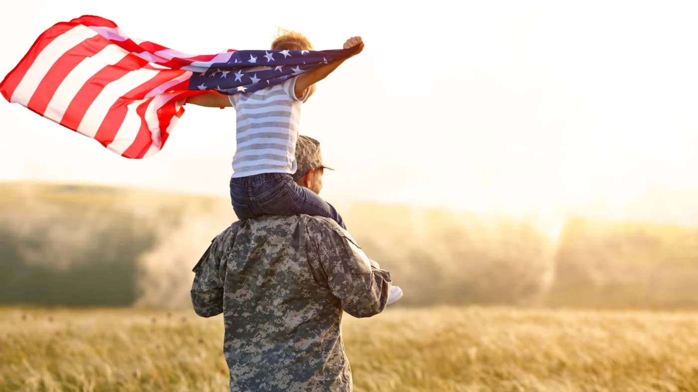 Universal Roof & Contracting crew honoring a veteran at a free roof replacement