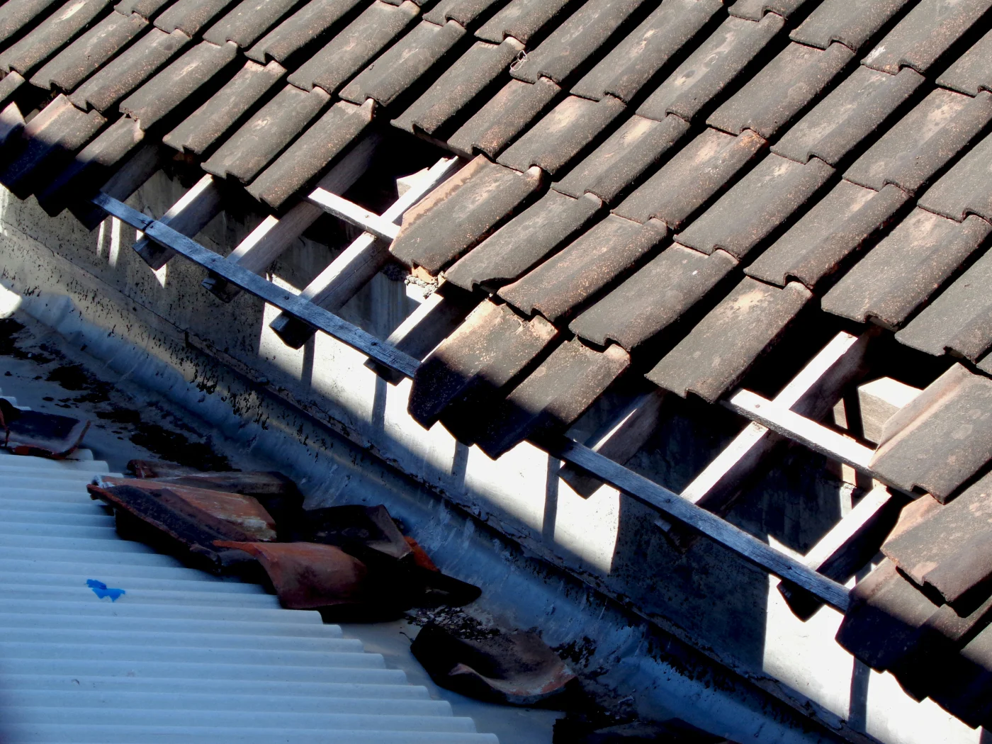 A close-up image of a metal roof stripped away by a storm