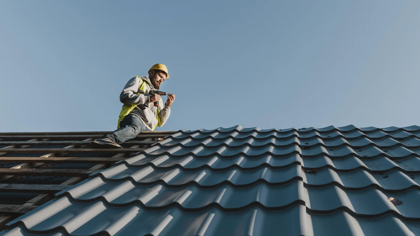 Roofer installing stone-coated steel roofing