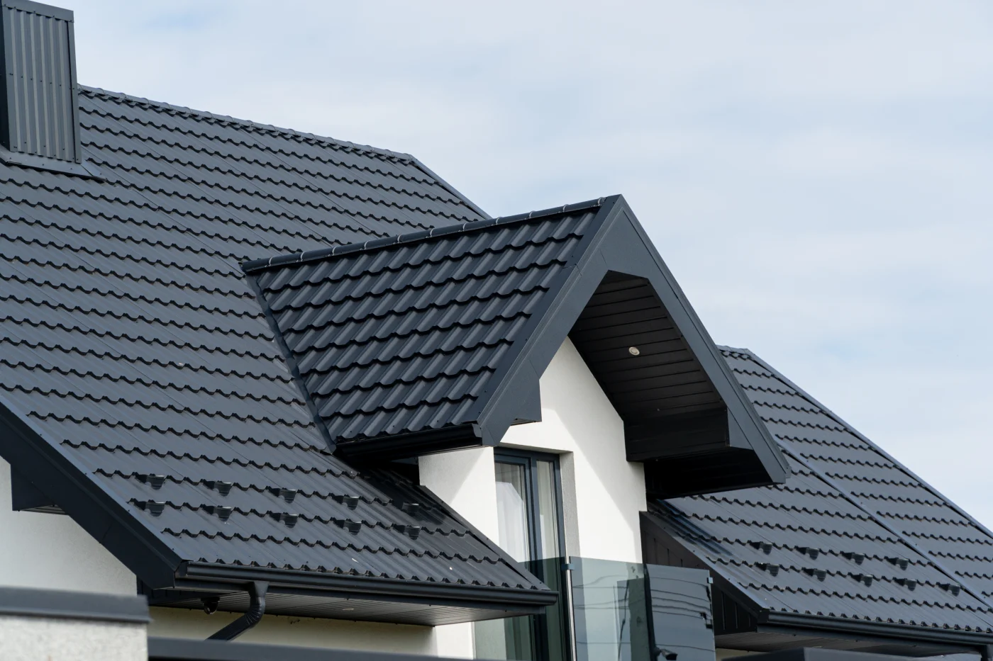 The Roof Of A Modern New House. Tiled Covering Of Building. Modern European House The Roof Of A Modern New House. Tiled Covering Of Building. Modern European House