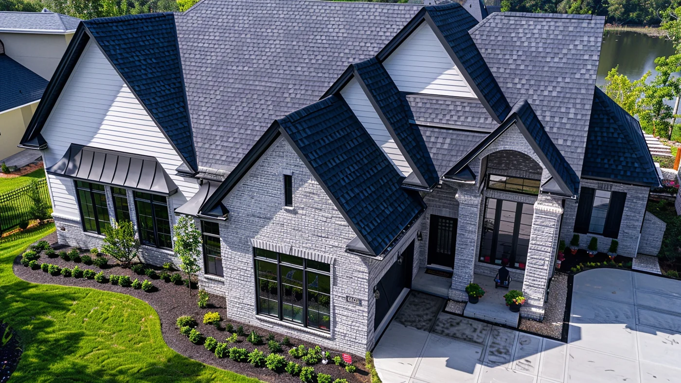 Home with green barn-style metal roofing and a small roof gable with a window on it