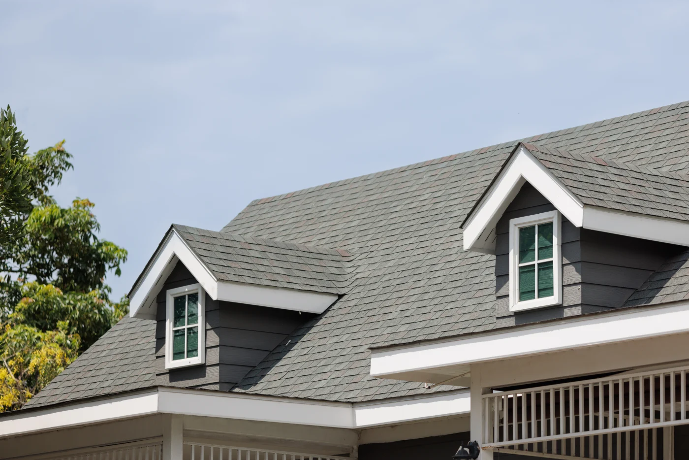 Asphalt shingle roof on a two-story house