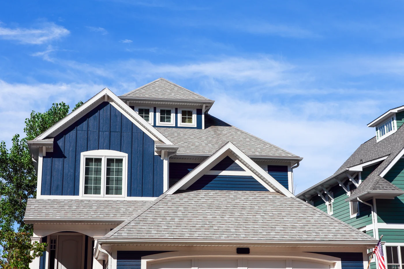 Close Up Row Of Beach Houses Alafaya home with dark blue siding and asphalt shingle roof worked on by Universal Roof & Contracting