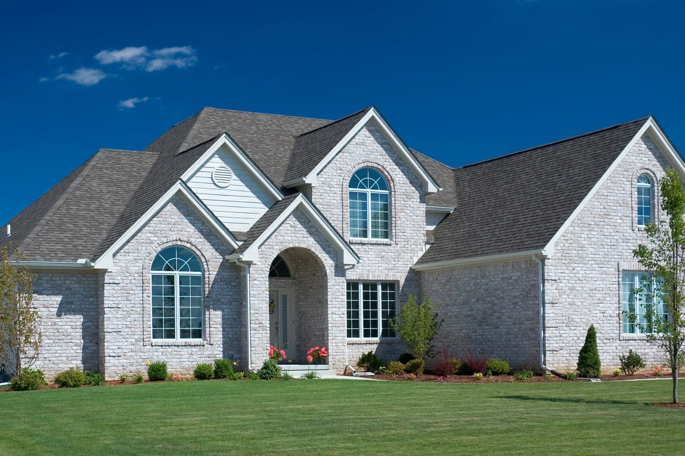 Beautiful Florida home with white interior and light and dark brown checkered Spanish tile roof
