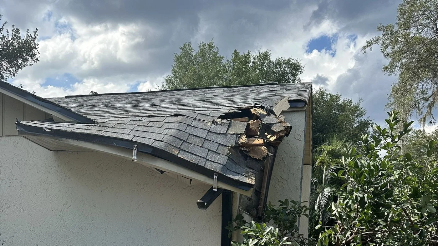 Emergency Repairs | Central Florida | Universal Roof & Contracting The corner of a home with a damaged roof In Central Florida | Universal Roof
