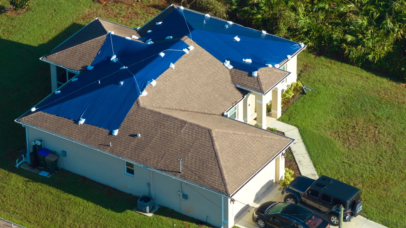 Image of a damaged, bent roof after a storm