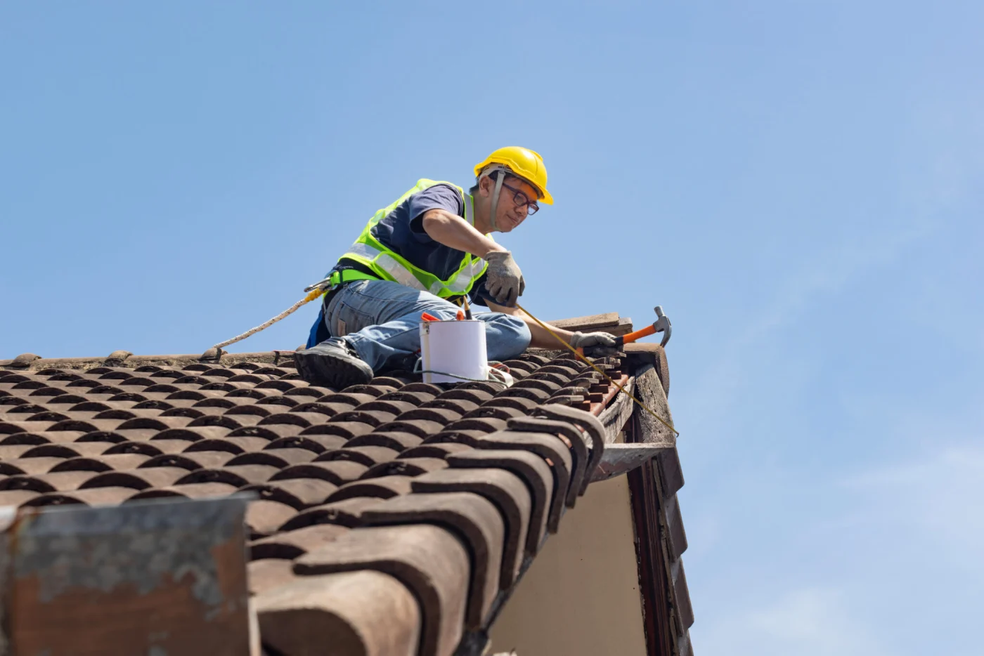 Worker Man Repairing Eaves And Tile Of The Old Roof.. Worker Man Repairing Eaves And Tile Of The Old Roof..