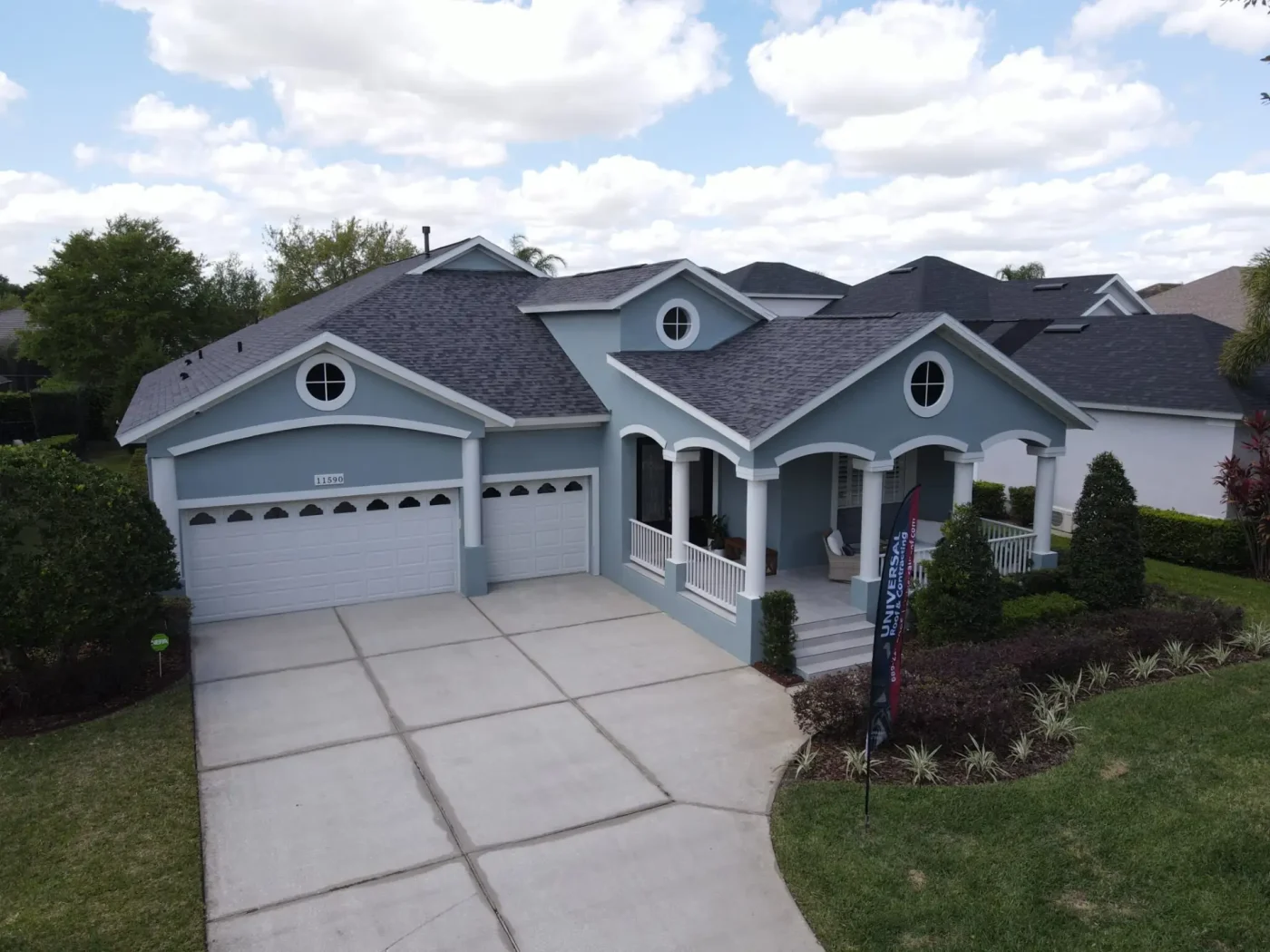 Majestic home with grey exterior and blue stone-coated roof