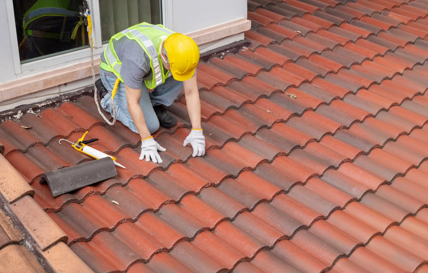 Close-up image of a man holding roof tiles