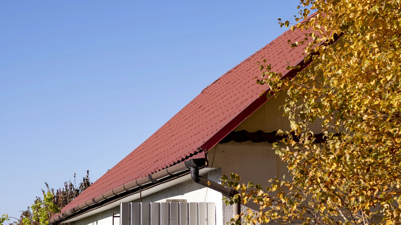 The Roof Is Made Of Red Metal Tiles In The Fall. The Roof Is Made Of Red Metal Tiles In The Fall.