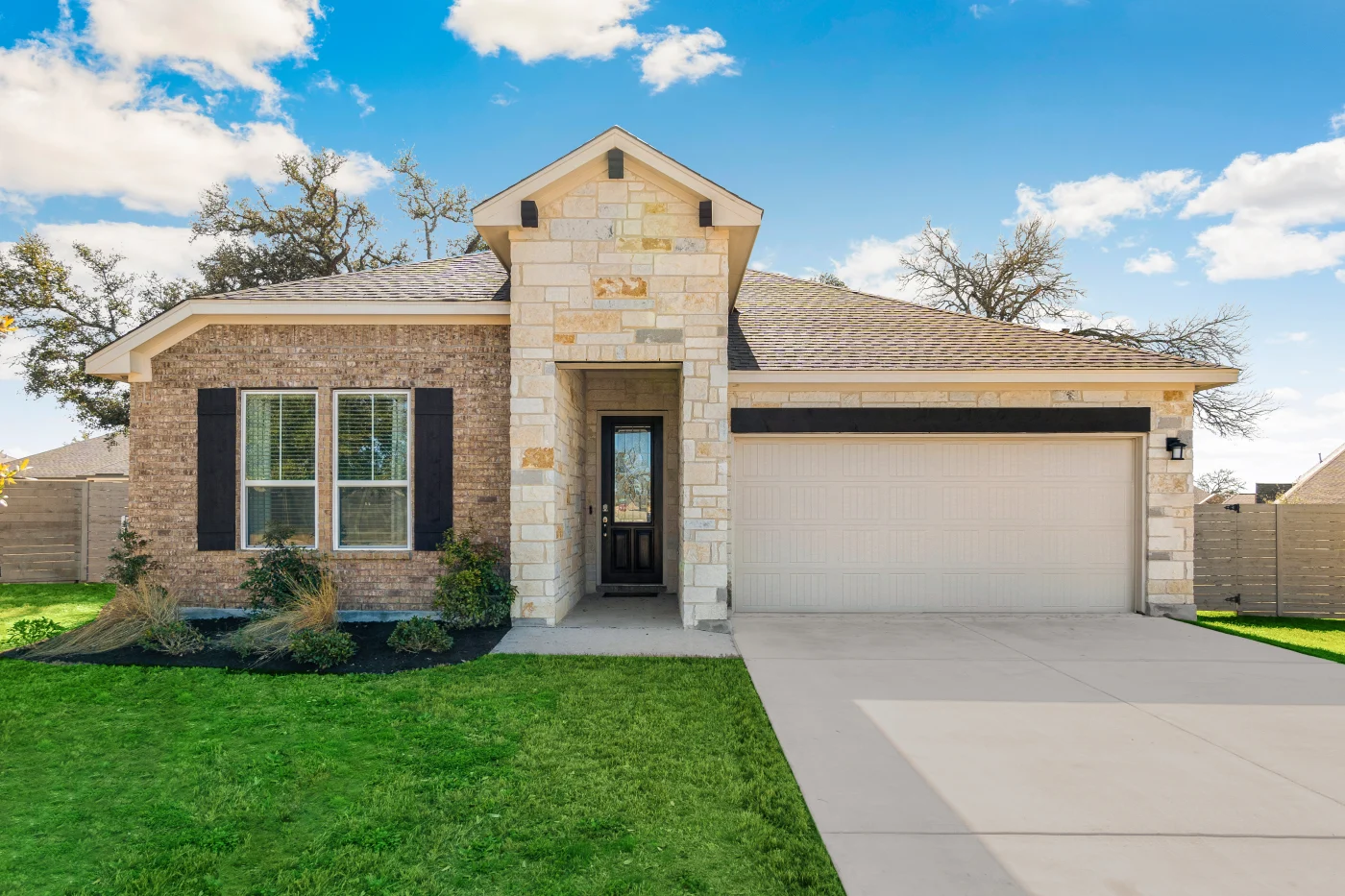 House with asphalt shingle roof and mixed stone and brick siding