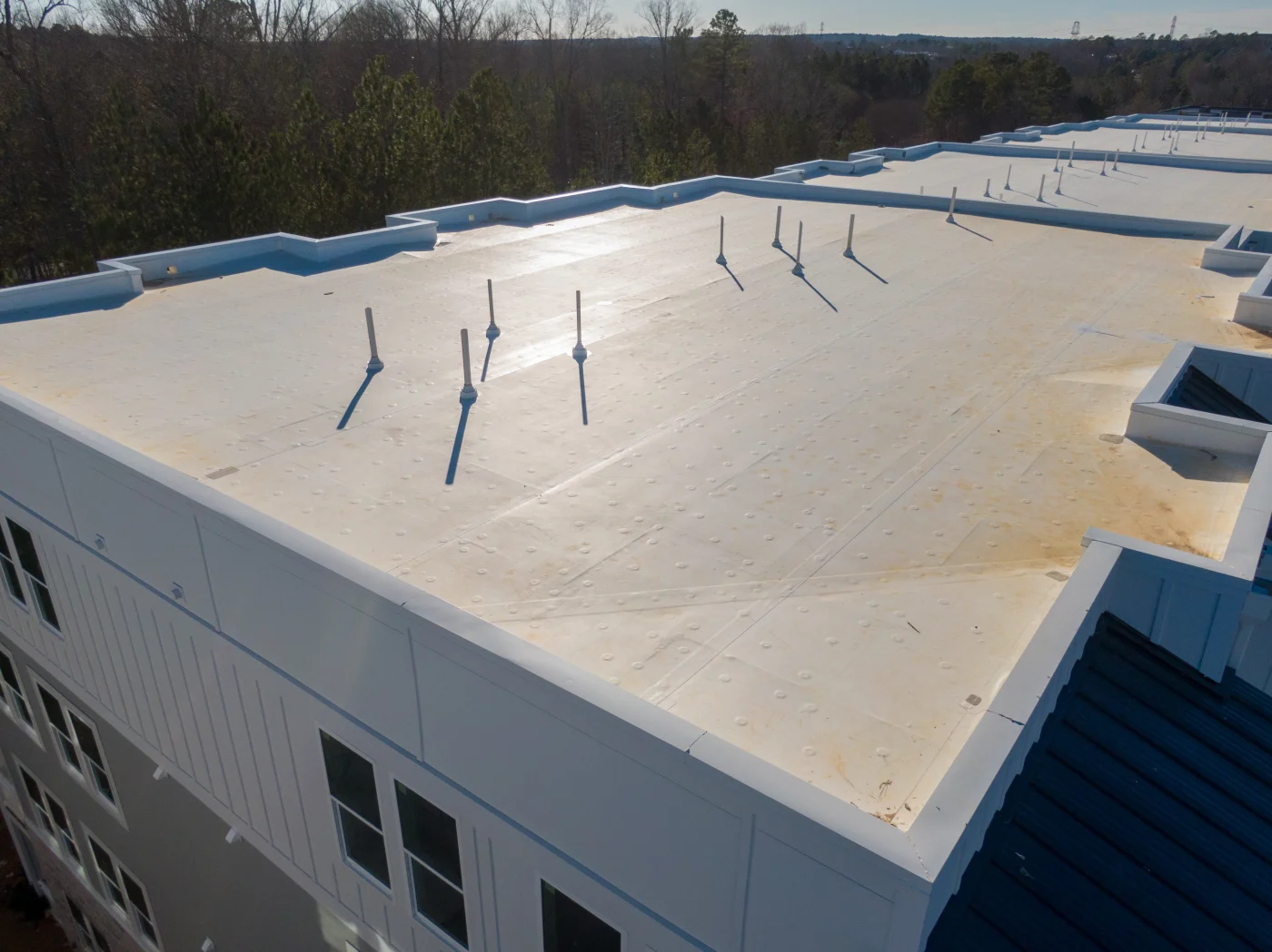 A view of a fresh looking flat roof on a commercial building.