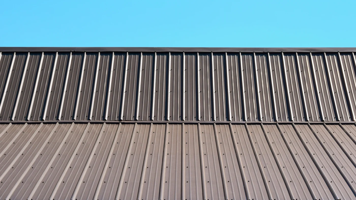 Asphalt shingled roof with window on roof gable and sky view