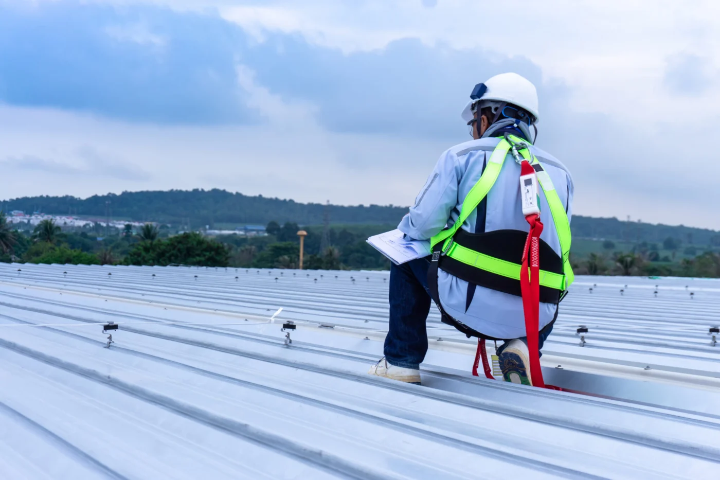 Engineer Wearing Full Safety Body Harness Working On Roof Top Engineer Wearing Full Safety Body Harness Working On Roof Top