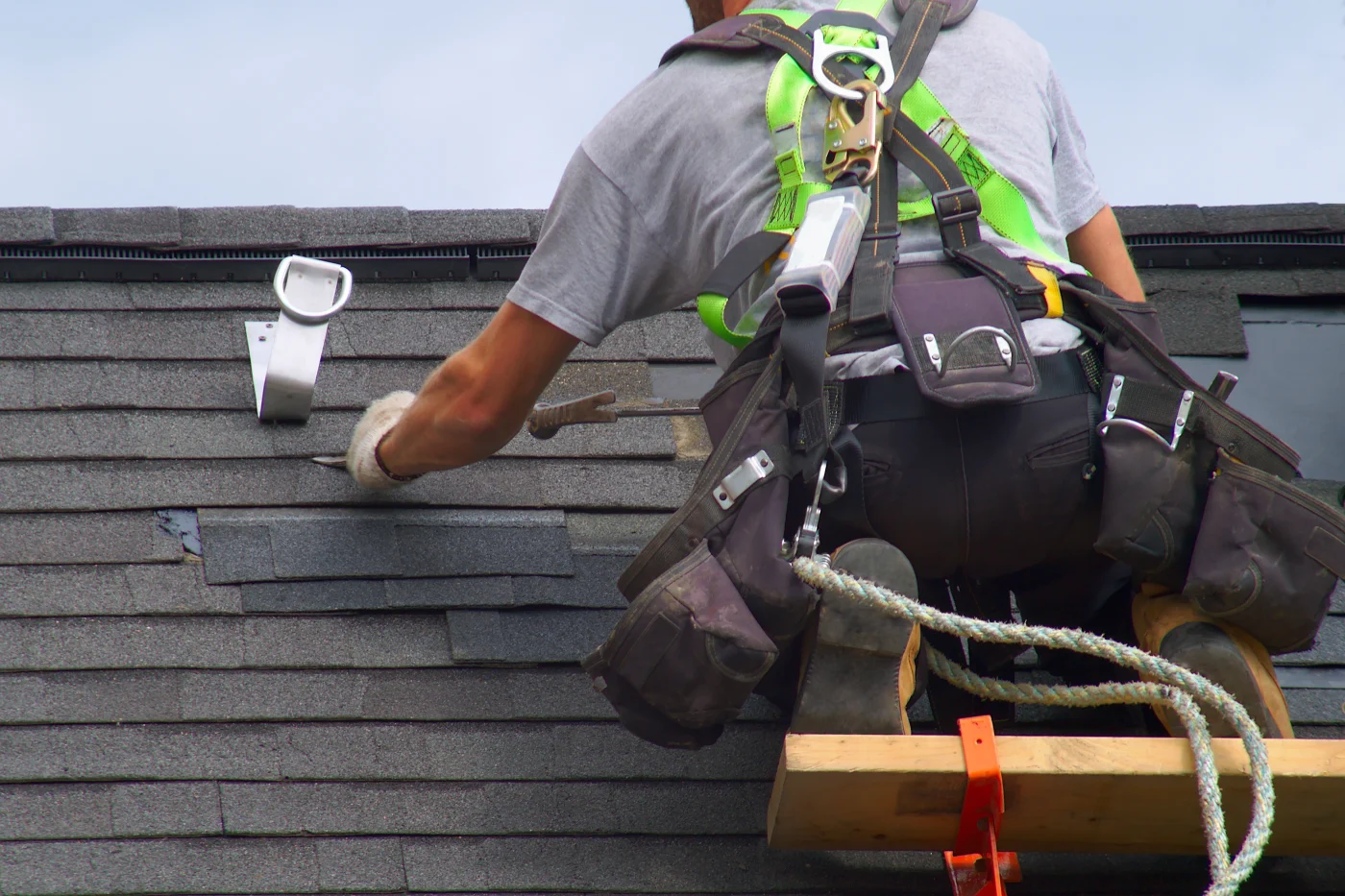 Roofer making roof repairs on a house