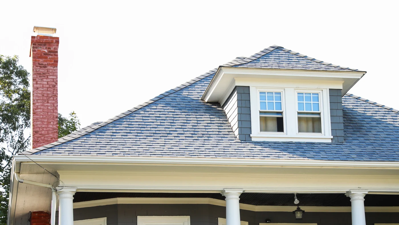 Brown metal roof with a sky view behind it