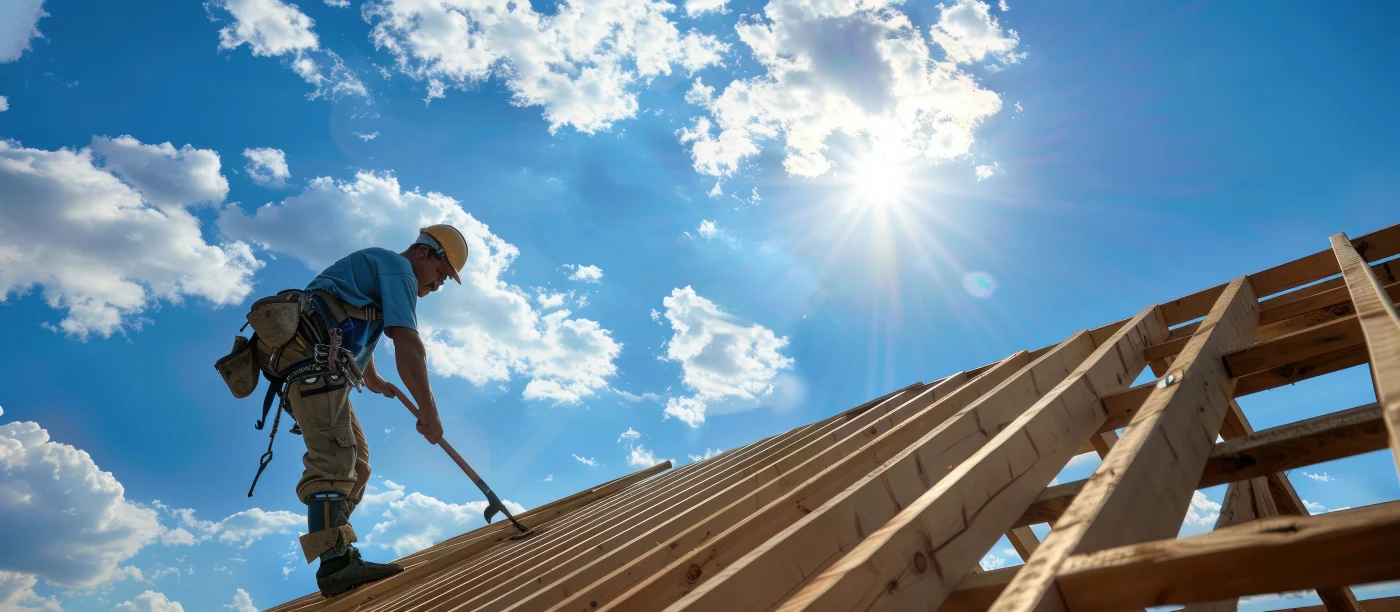 A construction worker standing on the roof deck