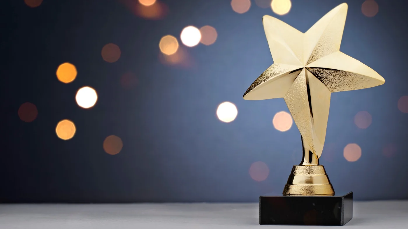 Roofing Awards And Associations | Central Florida | Universal Roof & Contracting A gold trophy with a star on top | Central Florida | Universal Roof & Contracting
