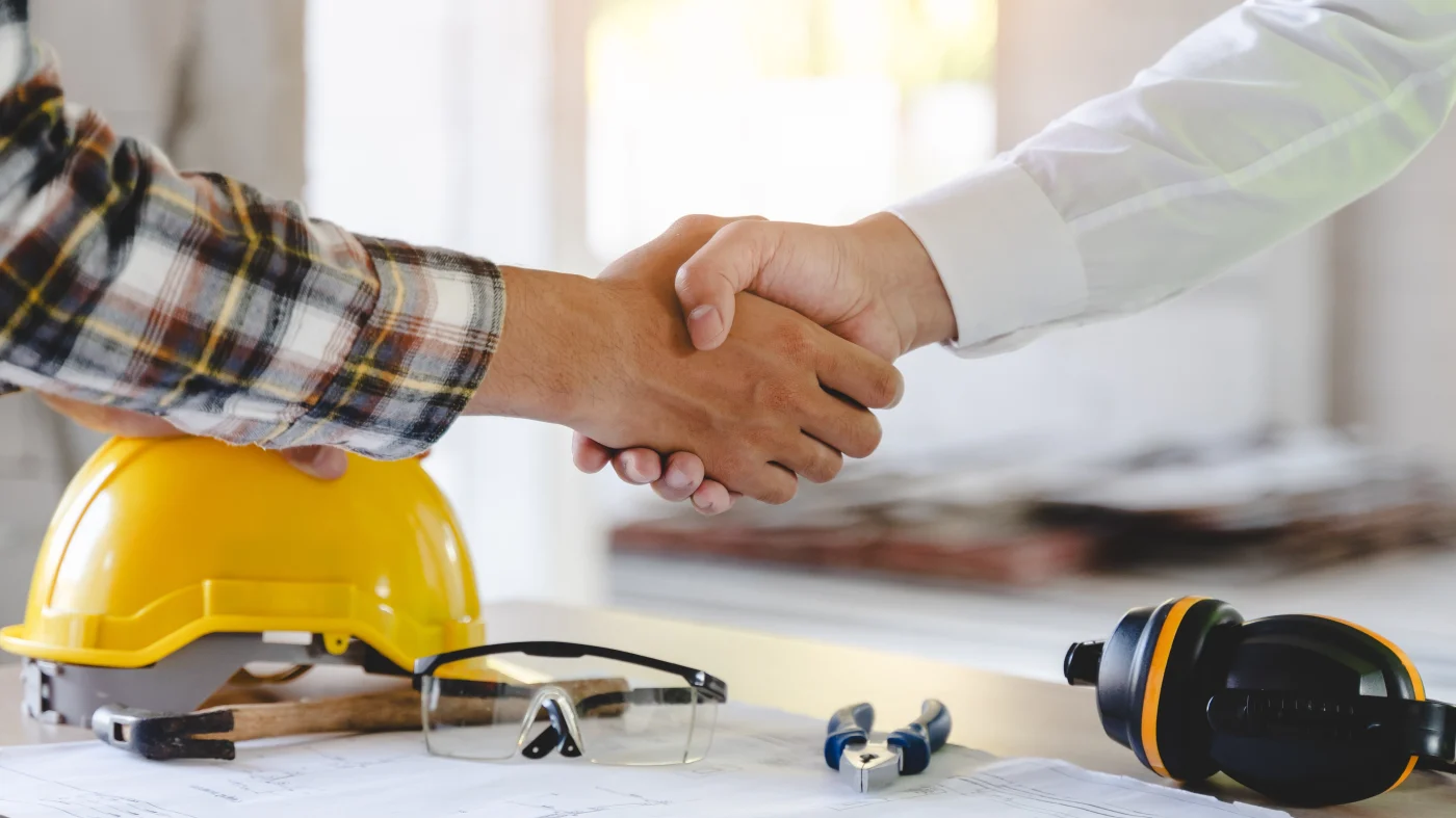 Roofing Employment | Central Florida | Universal Roof & Contracting A roofing supervisor and new hire shake hands in Central Florida | Universal Roof & Contracting