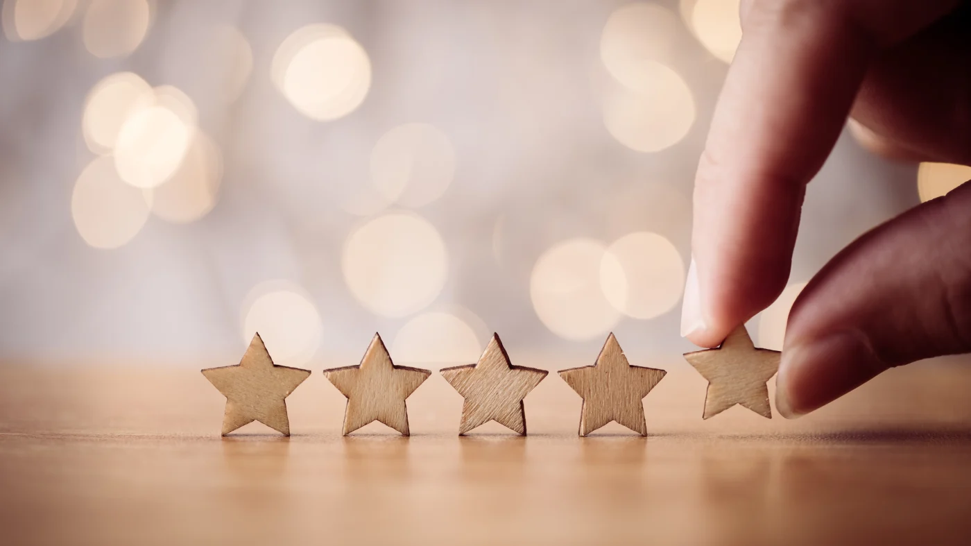 Roofing Reviews | Central Florida | Universal Roof & Contracting Four stars in a row with a hand placing a fifth star in the line in Central Florida | Universal Roof & Contracting
