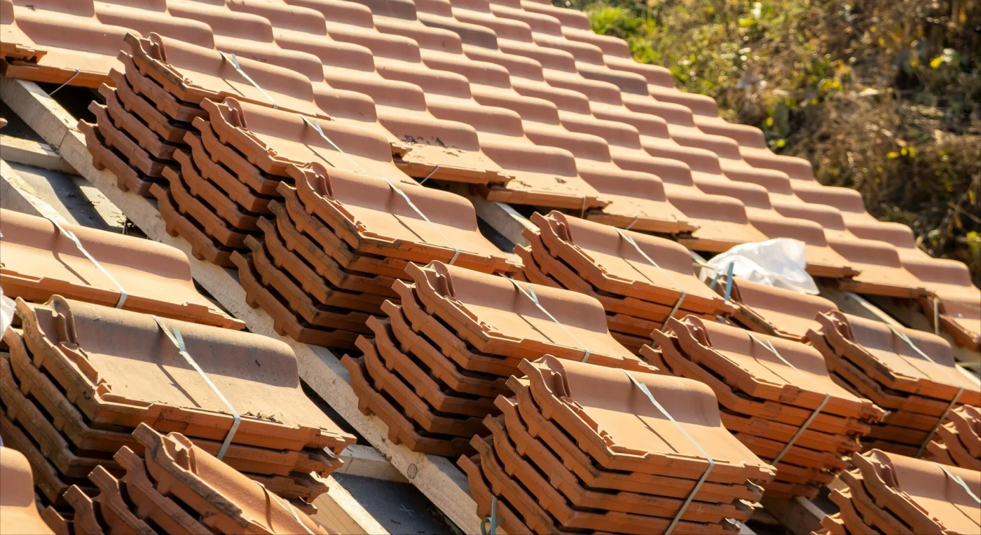Image of Spanish tiles on a residential roof, about to be installed