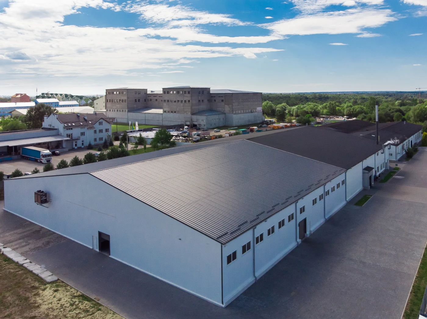 Image of a building’s commercial roof with another building behind it