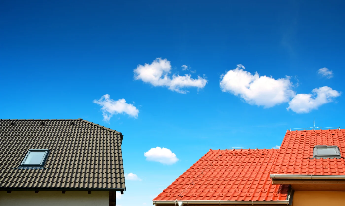 Roof House With Tiled Roof On Blue Sky. Roof House With Tiled Roof On Blue Sky.