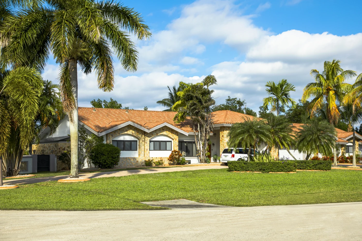 Tan house with Spanish tile roof installed