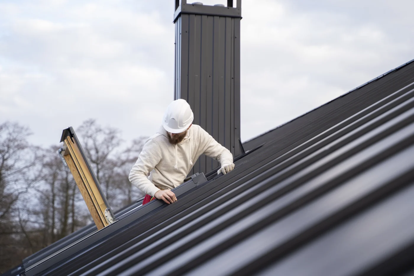 Man repairing a metal roof