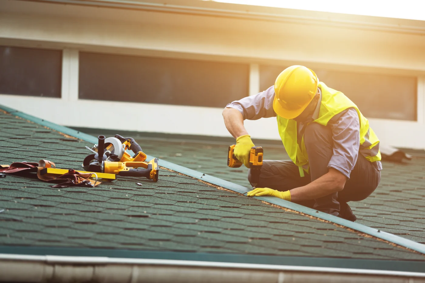 Professional roofer repairing seams on a roof