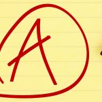 A yellow pad with an “A” drawn on it with a red marker. The marker is lying on the pad to the right of the letter.
