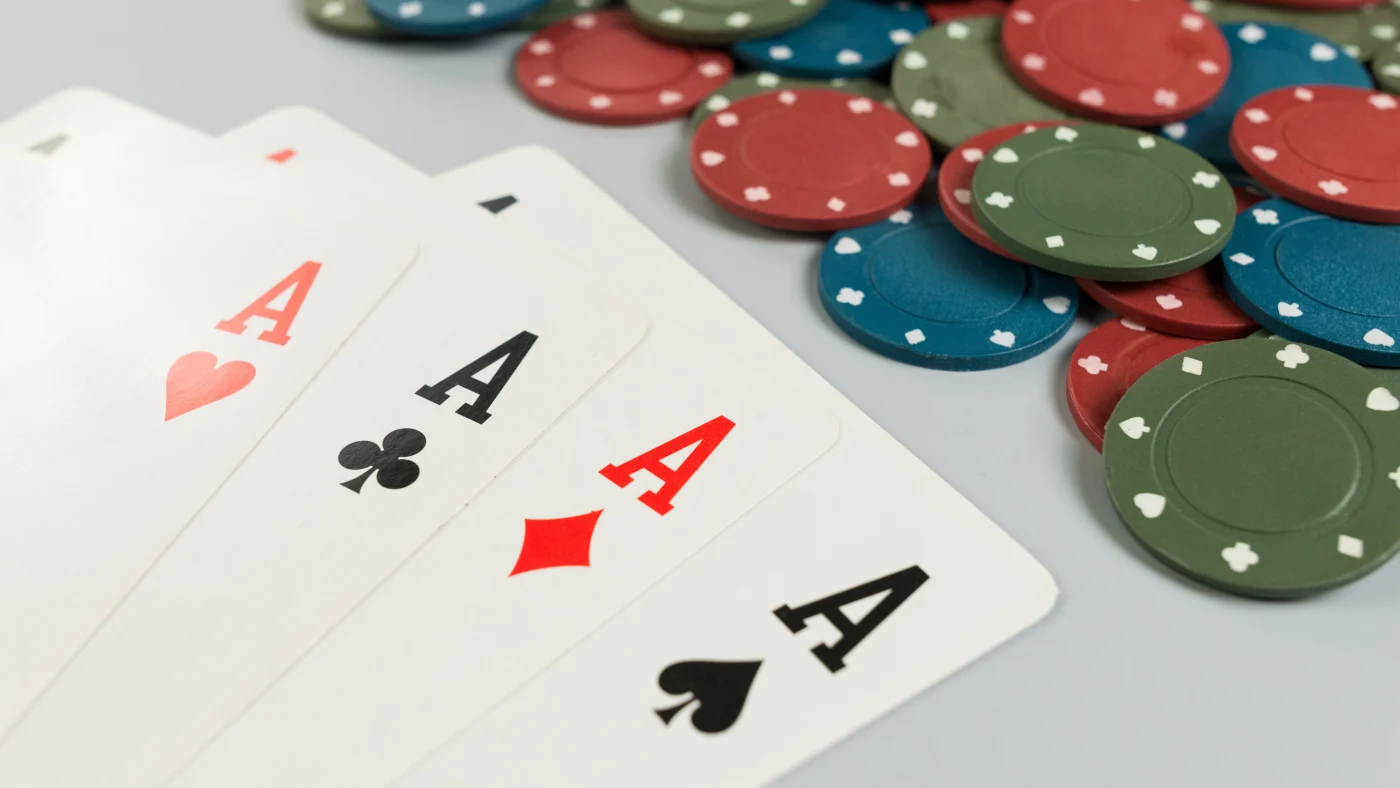 Dependable Roof Replacement | Jacksonville, FL | Universal Roof And Contracting Four of a kind aces laid out on a table in front of many poker chips.