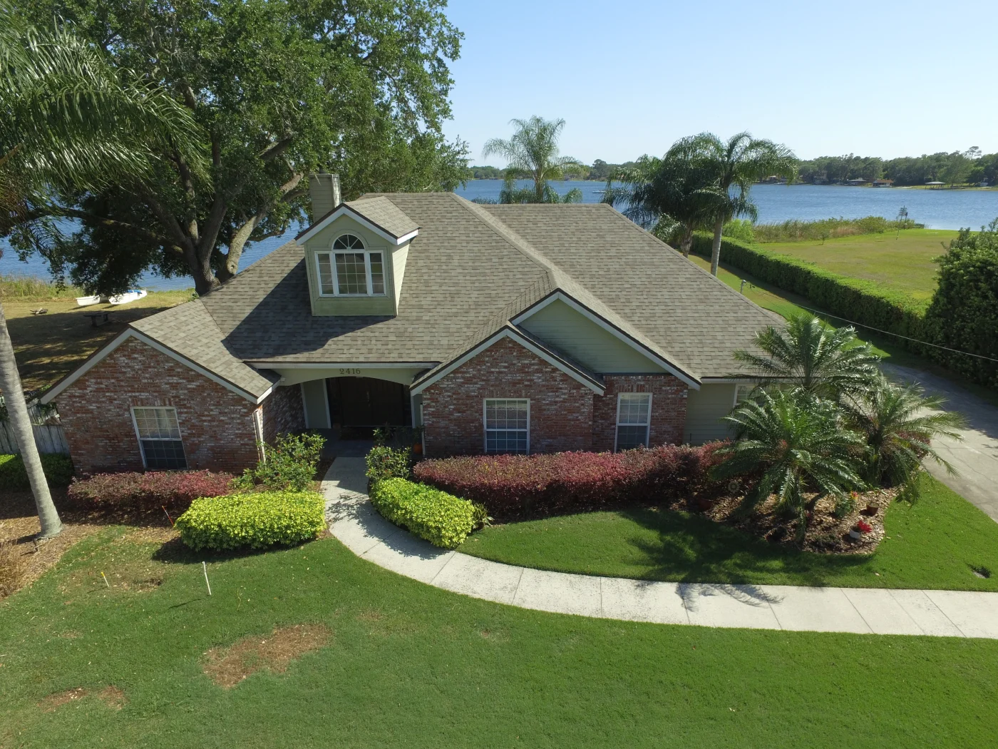 Aerial view of a multi-level, asphalt shingle roof on a newly constructed home.