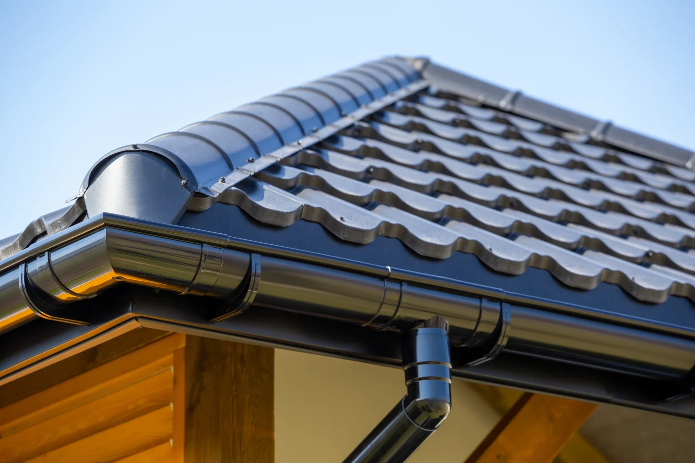 Close-up of high-performance gutters attached to the corner of a house.