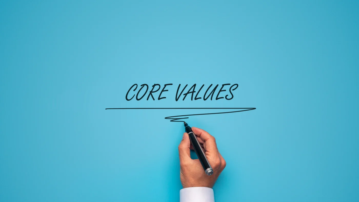 High Quality Roof Replacement | Central Florida & Jacksonville | Universal Roof and Contracting The words “Core values” are written in the middle of the image, with a hand holding a marker positioned below them.