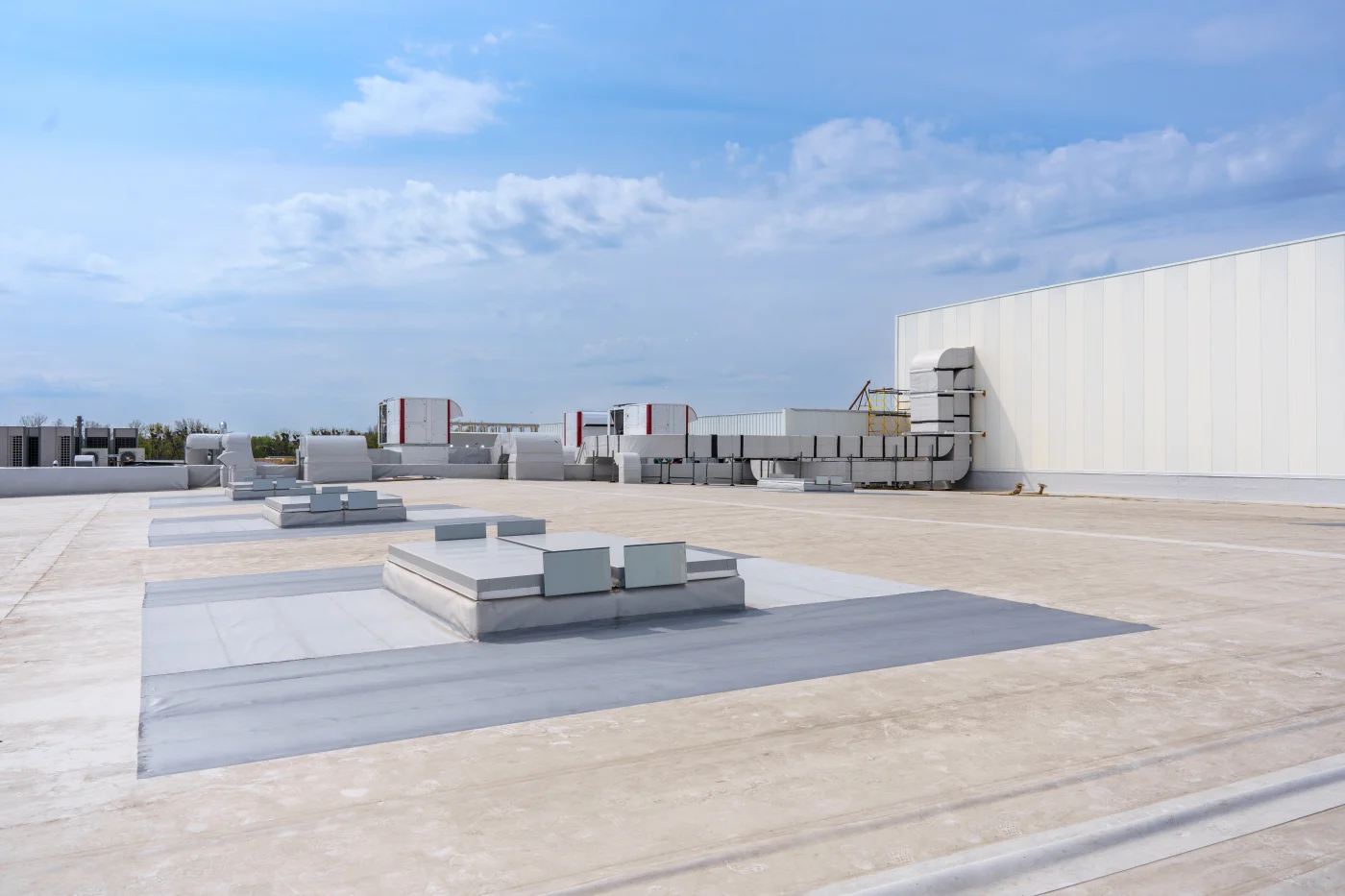 Multizone Air Conditioning And Ventilation System A flat commercial rooftop protects this building from the elements.