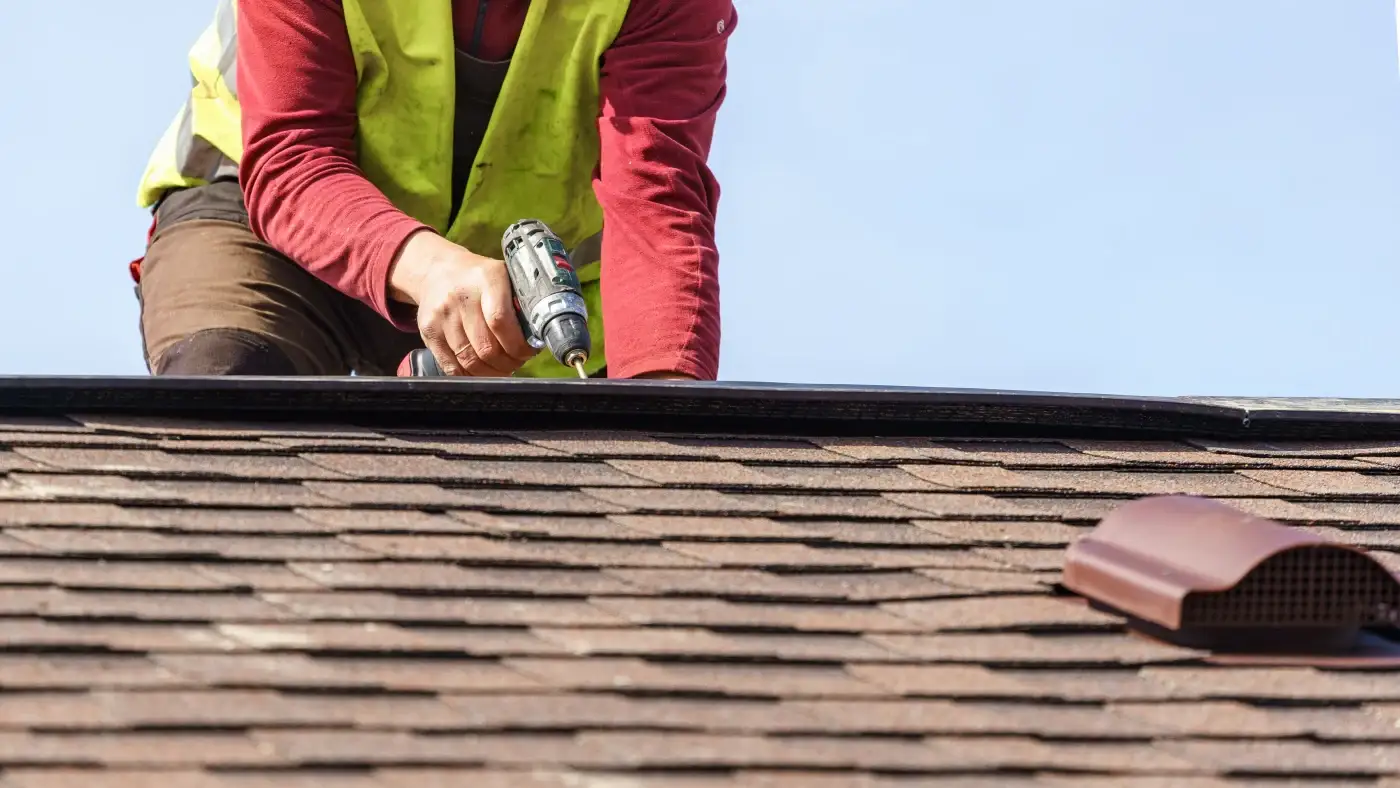 Asphalt shingles being installed on a Palm Coast, FL roof, with tools in the foreground.