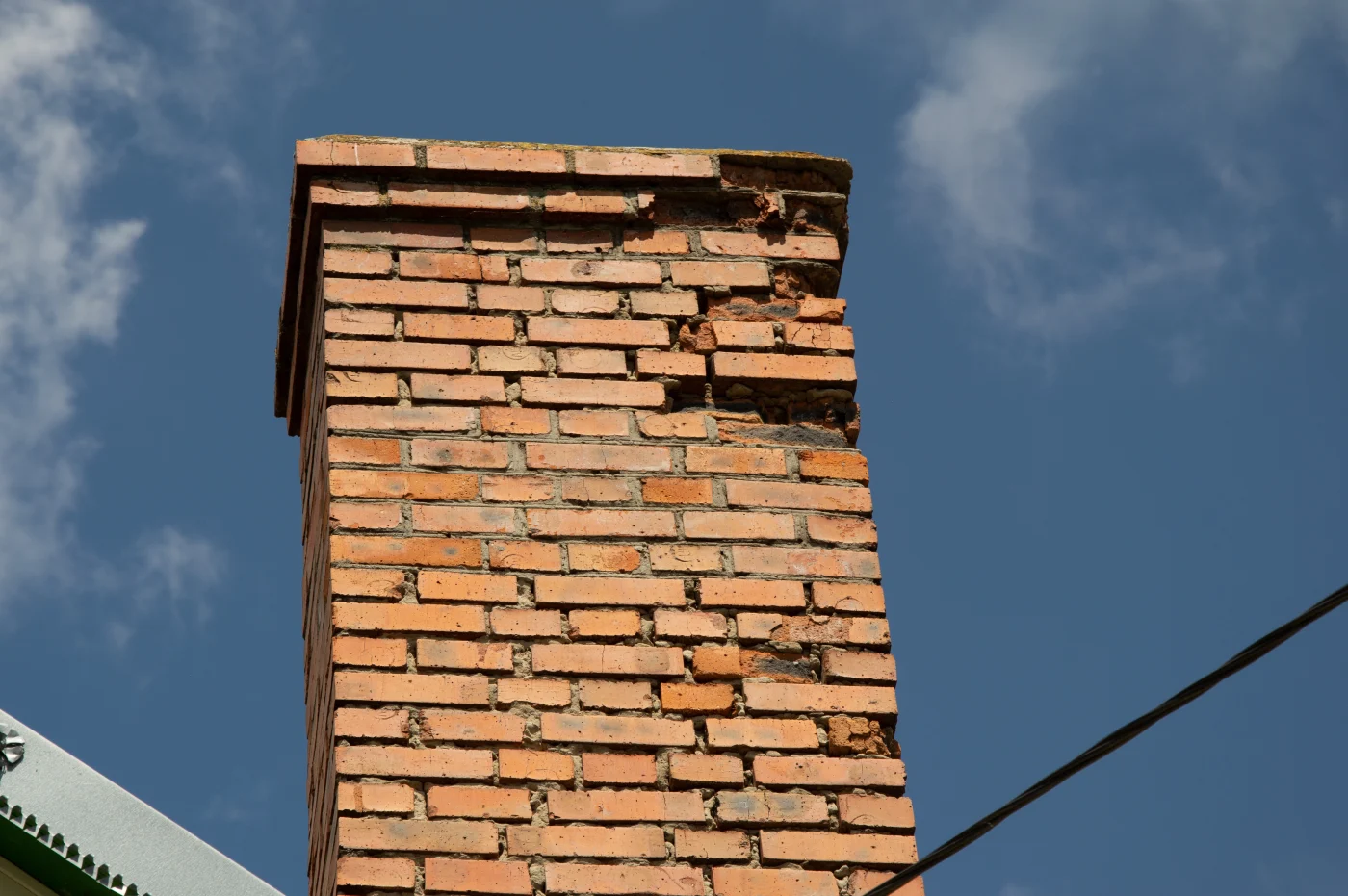 A Central Florida brick home with a newly restored and rebuilt chimney, completed by Universal Roof & Contracting as part of a detailed project.